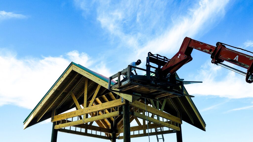 mechanical crane lifts shingles up on rooftop for 2023 11 27 04 53 27 utc 1